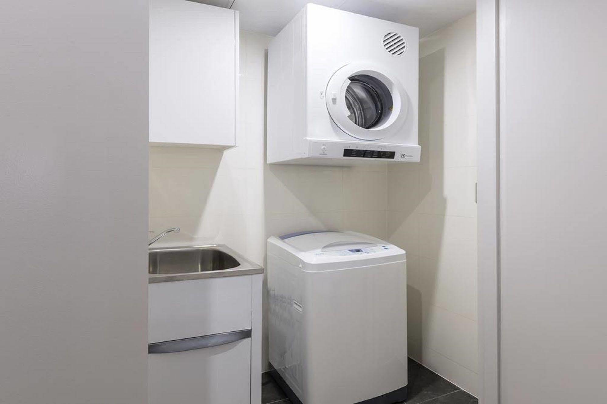 Meriton Suites North Sydney Exterior photo A laundry room with a washing machine and a dryer